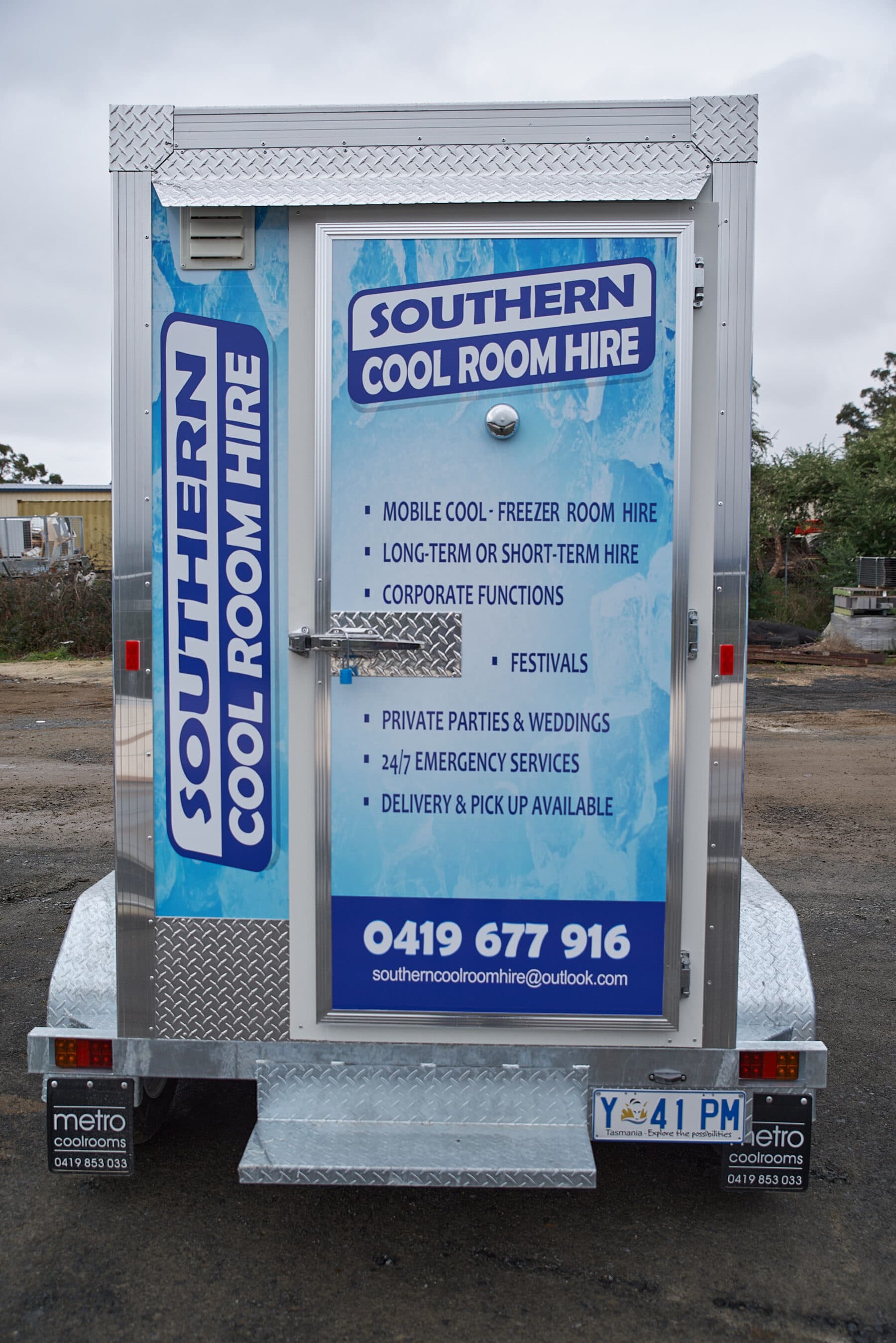 Rear of a freezer trailer showing the door and signage